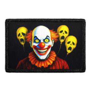 May include: A rectangular patch featuring a central clown with a white face, red nose, yellow eyes, and a wide grin, wearing a red ruffled collar. Three yellow skull-shaped balloons float in the black background behind the clown figure.