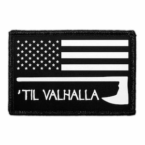 May include: Black rectangular patch featuring a white American flag design in the upper portion. Below the flag is the text "'TIL VALHALLA" in white, with a white axe graphic on the right side. The patch has a black border.