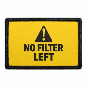 May include: A rectangular patch with a yellow background and a black border. The design features a black triangle containing an exclamation point above the black text NO FILTER LEFT, centered in a bold, sans-serif font on the yellow surface.