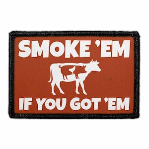 May include: A rectangular patch with a burnt orange background and a black border. It features white text that reads SMOKE 'EM IF YOU GOT 'EM. In the center is a white silhouette of a cow containing a smaller white silhouette of a pig and chicken.