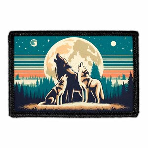 May include: A rectangular patch featuring a graphic illustration of three wolves howling at a large, pale yellow full moon. The scene includes a dark forest silhouette, a teal night sky with stars, and horizontal stripes in orange and blue tones.