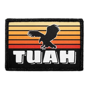 May include: A rectangular embroidered patch featuring a black silhouette of an eagle in flight against a background of horizontal stripes in yellow, orange, and red. The word TUAH is printed in large white capital letters at the bottom.