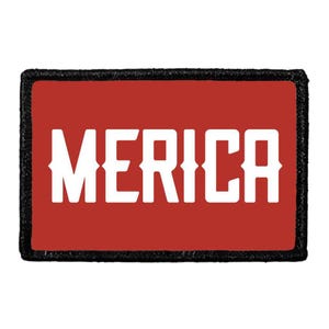 May include: A rectangular patch with a red background and a thick black border. The word MERICA is printed in large, bold, white capital letters across the center of the patch. The font features a distinct western-style serif design.