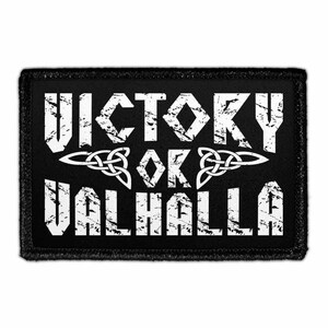 May include: A rectangular black patch with a distressed white graphic print. The text reads VICTORY OR VALHALLA in a bold, weathered font. Between the words is a white triquetra knot symbol. The patch has a stitched border edge.