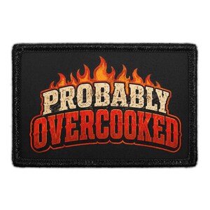 May include: A rectangular black patch featuring a graphic of orange and yellow flames at the top. Below the flames, the text PROBABLY is printed in a distressed beige font, followed by the word OVERCOOKED in a bold, distressed red font.