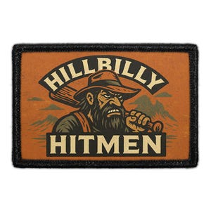 May include: Rectangular patch with a black border. The patch features a cartoon illustration of a bearded man in a hat holding a club. The words "HILLBILLY" and "HITMEN" are arched above and below the illustration, respectively. The background is orange.