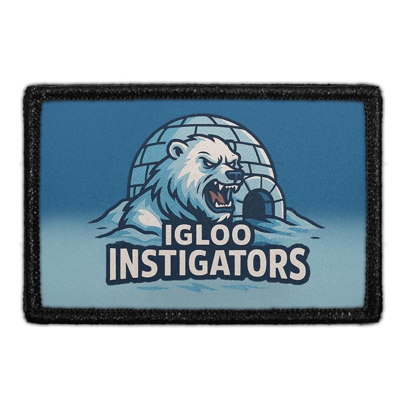 May include: A rectangular patch with a black border. The patch features a blue background with a white polar bear emerging from an igloo. The text "IGLOO INSTIGATORS" is below the bear.
