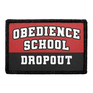 May include: A rectangular embroidered patch with a black border. The top half is red with the white text OBEDIENCE SCHOOL in a bold, block font. The bottom half is black with the white text DROPOUT in a matching bold, block font style.