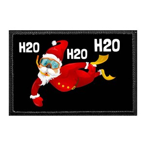 May include: A black patch featuring a cartoon Santa Claus wearing a snorkel and flippers, with the text "H2O" in white. Santa is depicted in a red suit and hat, with a white beard and blue goggles. The image has a black border.