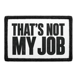 May include: A rectangular patch with a white background and a thick black border. The text THAT'S NOT MY JOB is printed in bold, black, sans-serif capital letters across the center of the patch, featuring a slightly distressed texture.