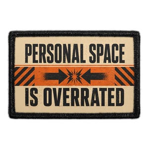 May include: A rectangular patch with a cream background and a black border. The text reads PERSONAL SPACE IS OVERRATED in black capital letters. A central orange horizontal band features two black arrows pointing inward toward a starburst.