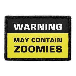 May include: A rectangular patch with a black border. The top section is black with the white text WARNING. The bottom section is yellow with the black text MAY CONTAIN ZOOMIES. The design mimics a standard safety warning sign.