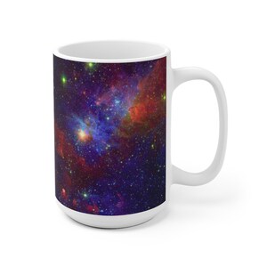May include: White ceramic mug with a colorful nebula image. The image features a swirling mix of red, blue, and purple hues with a scattering of stars.