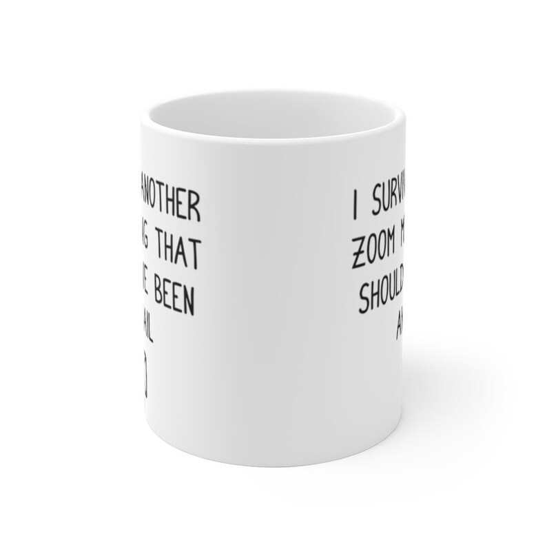 May include: White ceramic coffee mug with black text that reads "Another meeting that could have been an email" on the left side and "I survived another zoom meeting that should have been an email" on the right side.
