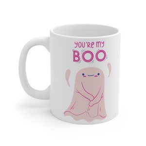 May include: White ceramic coffee mug with a pink ghost illustration and the text "You're my BOO" in pink lettering.
