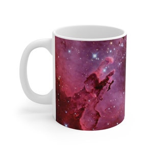 May include: White ceramic mug with a colorful image of the Eagle Nebula, a star-forming region in the constellation Serpens.