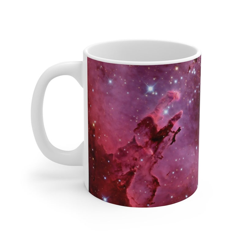 May include: White ceramic mug with a colorful image of the Eagle Nebula, a star-forming region in the constellation Serpens.