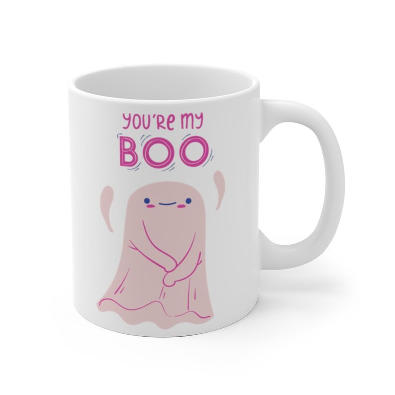 May include: White ceramic coffee mug with a pink ghost illustration and the text "You're my BOO" in pink letters.