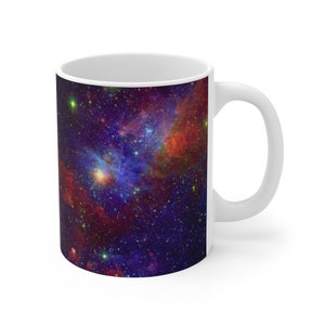 May include: White ceramic mug with a colorful nebula image. The image features a swirling mix of red, blue, and purple hues with scattered stars.