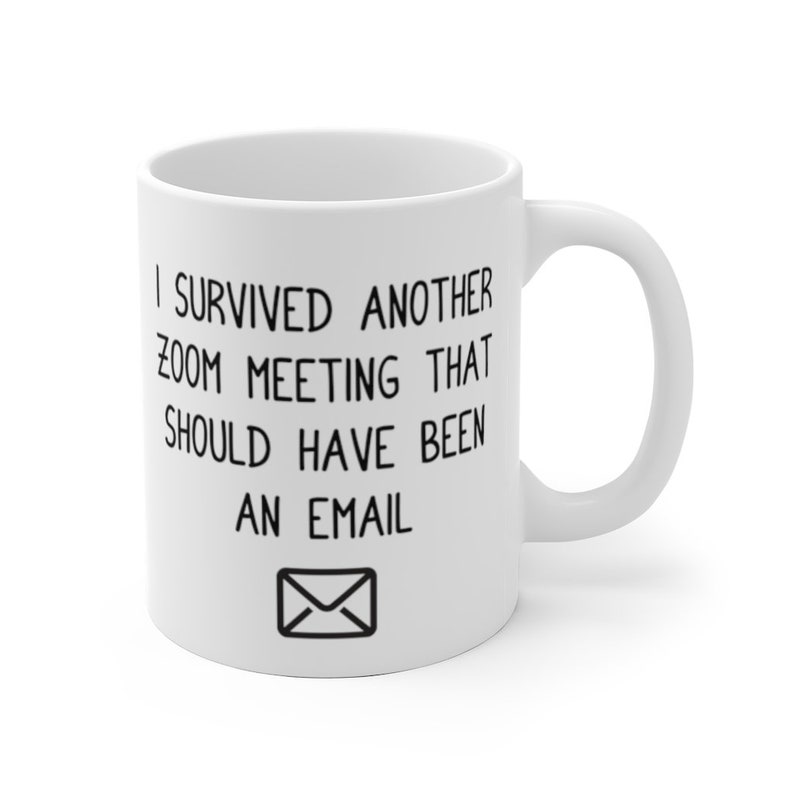 May include: White ceramic coffee mug with black text that reads "I survived another zoom meeting that should have been an email" and an envelope icon.