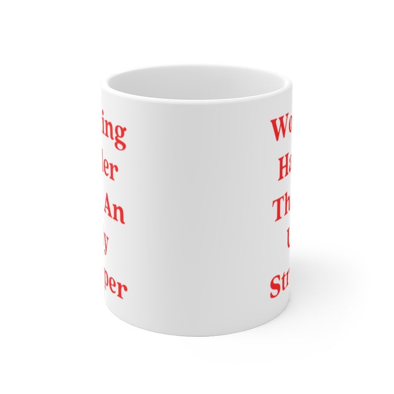 May include: White ceramic mug with red text that reads "Working harder than a super hero" on the left side and "Work hard, have fun, then do it again" on the right side.