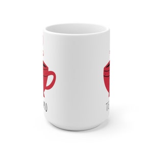 May include: White ceramic mug with a red illustration of a teacup and the text "Te Amo" on the side.