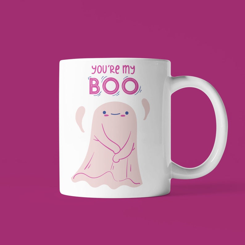 May include: White ceramic coffee mug with a pink ghost illustration and the text "You're my BOO" in pink lettering.