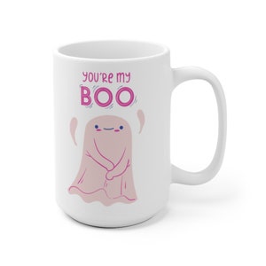 May include: White ceramic coffee mug with a pink ghost illustration and the text "You're my BOO" in pink letters.