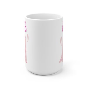 May include: White ceramic mug with a pink ghost illustration and the text "Boo-tiful" in pink and purple lettering.