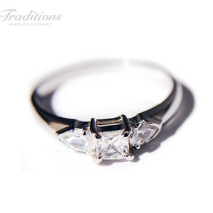 Sterling silver ring with square cut cubic zirconia stone with one stones on each side