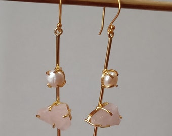 May include: Gold earrings with a pink stone and a pearl on each earring.
