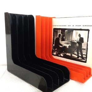 Two 70s vinyl racks - Gustavsberg and Discofoon record stands in groovy orange and black plastic - L-shaped retro vinyl storage