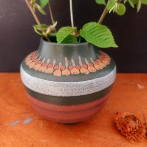 Könnte beinhalten: Rustikales Holzschild mit dem handgeschriebenen Text "Welcome to our home". Das rechteckige Schild hat eine Used-Optik und ein schlichtes, einladendes Design. Geeignet für den Innen- und Außenbereich.