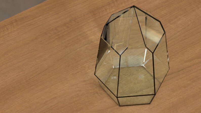 May include: A geometric terrarium with a clear glass design and black trim. The terrarium has multiple facets and is empty. The object is placed on a light brown wooden surface.