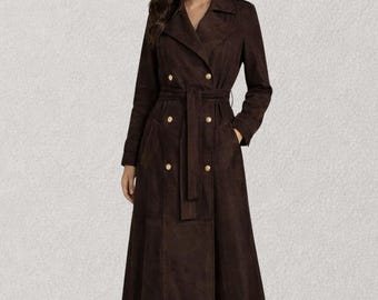 May include: A long, dark brown trench coat featuring a double-breasted front with gold-toned buttons, a wide notched collar, long sleeves, and a matching fabric belt that cinches at the waist. The coat has a structured silhouette and falls below the knee.