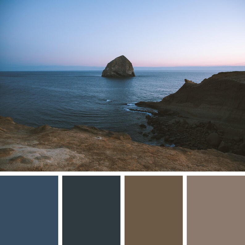 May include: A scenic coastal landscape featuring a large rock formation in the ocean. The water is a deep blue, and the sky transitions from blue to pink. The foreground shows a brown, rocky cliff.