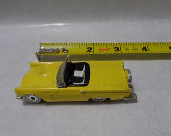 1:18 scale yellow 1957 Ford Thunderbird die-cast collectible toy car.