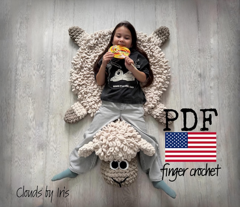 May include: A white crocheted sheep rug with a child sitting on it. The rug is made using finger crochet and has a fluffy texture. The child is holding a lollipop and wearing jeans. The text "PDF finger crochet" and an American flag are visible in the image.