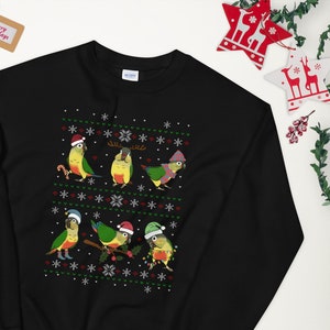May include: Black Christmas sweater with a festive pattern of green and yellow parrots wearing Santa hats and reindeer antlers. The sweater has a white snowflake design.