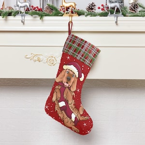 May include: Red Christmas stocking with a plaid cuff and a cartoon image of a brown dog wearing a Santa hat and a red scarf.