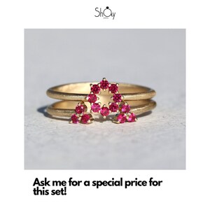 May include: A gold ring set with two bands, the top band features a star shape made of small pink gemstones. The text "Ask me for a special price for this set!" is below the image.
