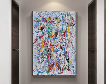 Puede incluir: Pintura abstracta con salpicaduras de pintura de colores sobre un fondo blanco. La pintura está enmarcada en negro y está colgada en una pared de un pasillo.