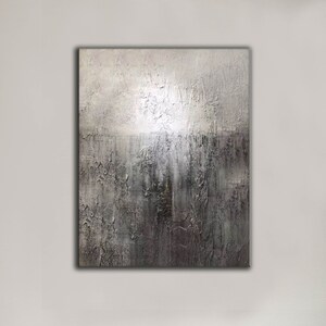 May include: Abstract painting with a textured surface. The painting is in shades of gray and white, with a darker gray area at the bottom. The texture of the paint creates a sense of depth and movement.