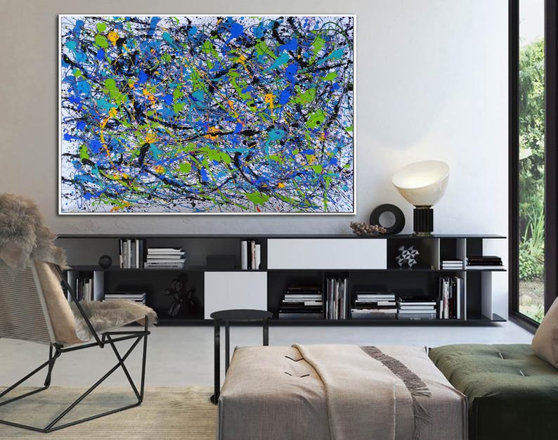 May include: Abstract painting with a white background and splashes of blue, green, yellow, and black paint.