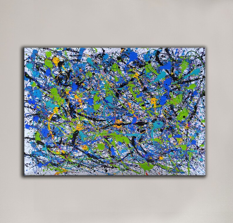 May include: Abstract painting with a white background and a variety of colours including black, blue, green, yellow, and orange. The paint is applied in a splatter technique, creating a dynamic and energetic composition.