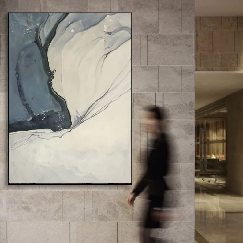 May include: Abstract painting with a blue and white color scheme. The painting features a large, flowing shape in the center, with smaller shapes and lines surrounding it.