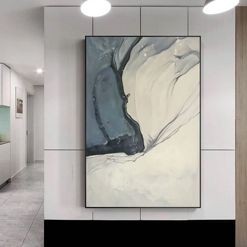 May include: Abstract painting with a white background and a large blue and black shape in the center. The shape is surrounded by thin, white lines.