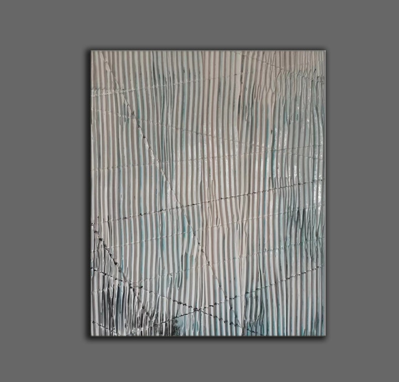 May include: Abstract painting with a textured surface. The painting features a pattern of vertical stripes in shades of blue and white, with a subtle hint of brown. The stripes are slightly wavy, creating a sense of movement. The painting is framed in a simple black frame.