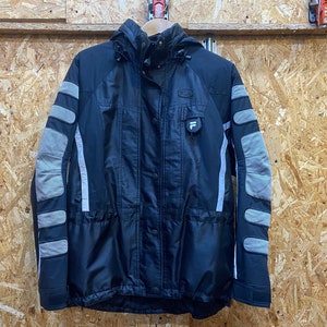 May include: Black and gray winter jacket with a hood. The jacket features gray padded sections on the sleeves and a small logo on the chest. The jacket has a button and zipper closure.