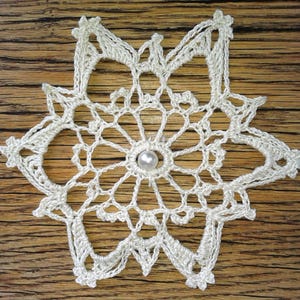 Crocheted star, doily with pearl, ice crystal, crocheted ice flower 17 cm